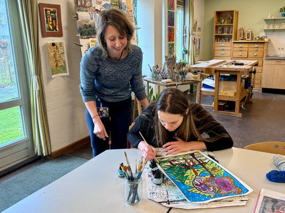 Een vrouw naast een vrouw die schildert